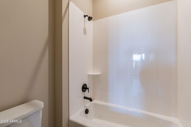 bathroom featuring shower / bath combination and toilet