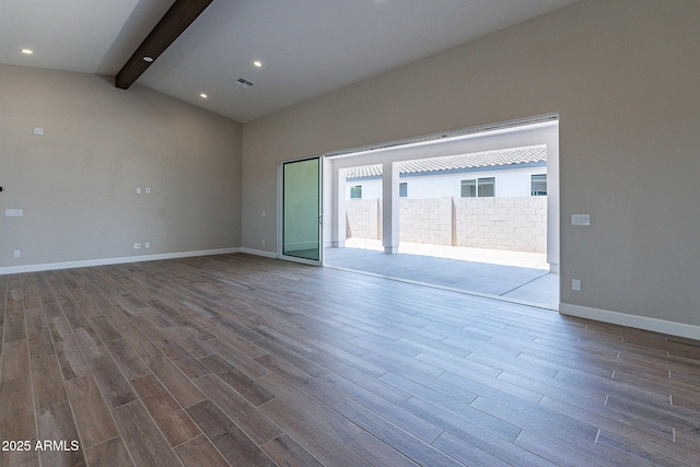 empty room with vaulted ceiling with beams, recessed lighting, wood finished floors, visible vents, and baseboards