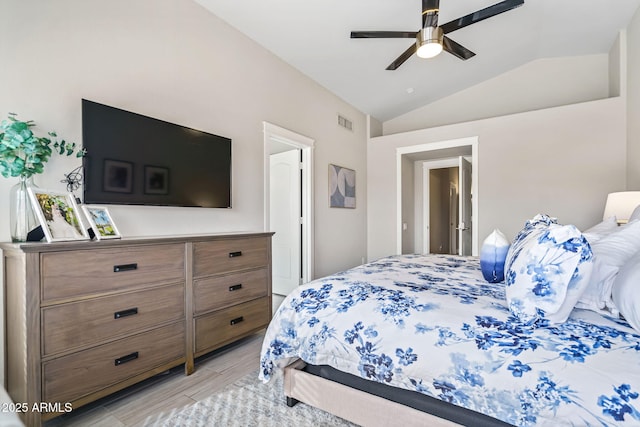 bedroom with lofted ceiling, light hardwood / wood-style floors, and ceiling fan