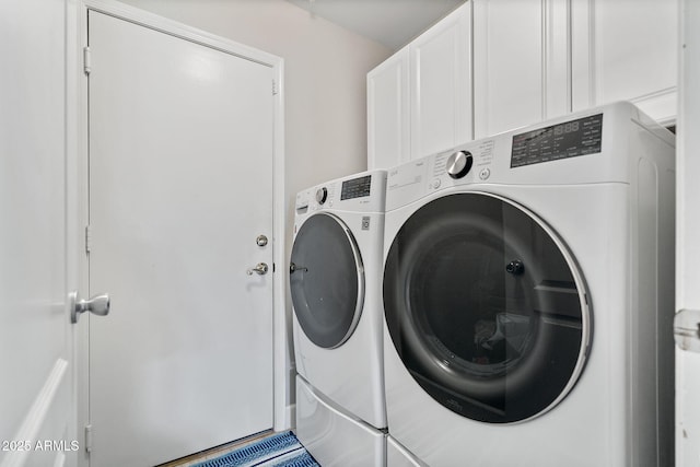 laundry area with cabinets and independent washer and dryer