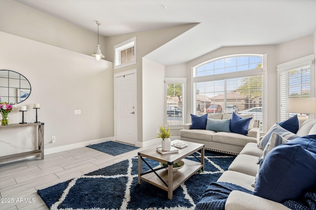 living room featuring lofted ceiling, light hardwood / wood-style floors, and a wealth of natural light