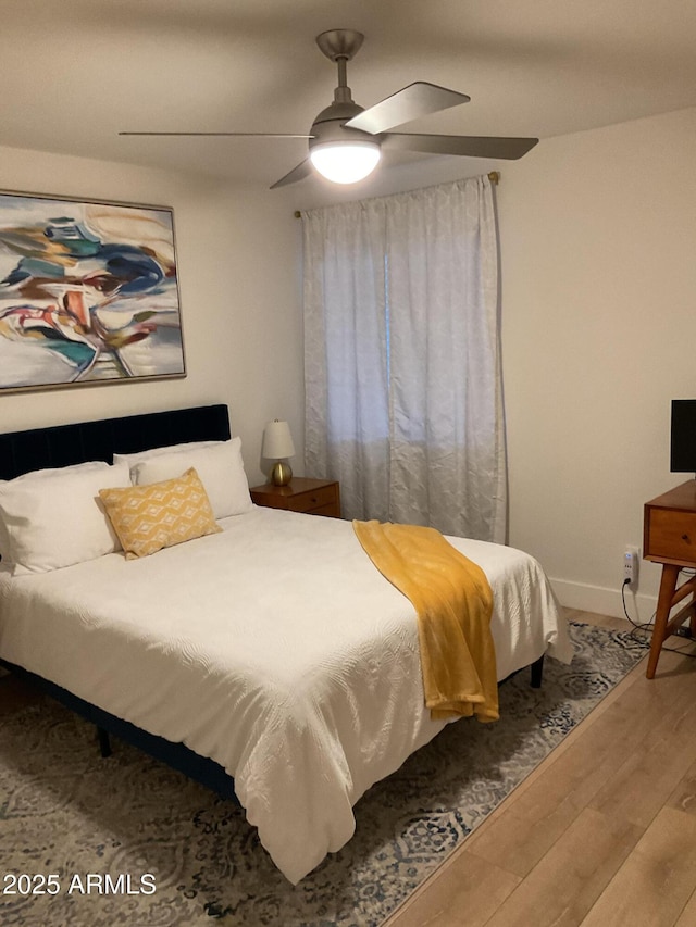 bedroom with ceiling fan and wood-type flooring