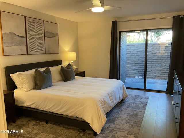 bedroom featuring wood-type flooring, access to outside, and ceiling fan