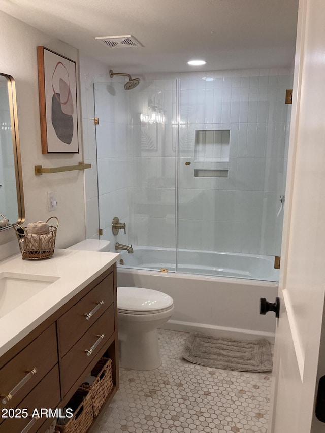 full bathroom with tile patterned floors, vanity, toilet, and tiled shower / bath combo