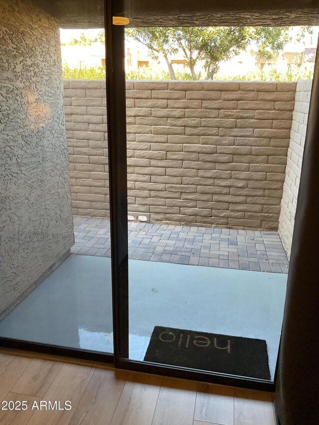 doorway with hardwood / wood-style flooring