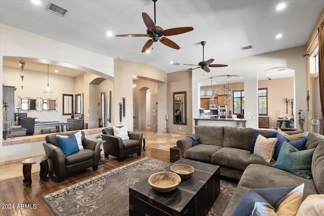 living room featuring ceiling fan and dark hardwood / wood-style flooring