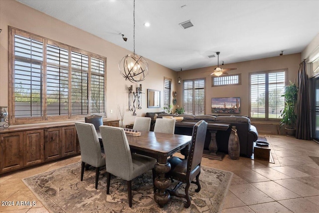 dining space featuring light tile patterned floors and ceiling fan with notable chandelier