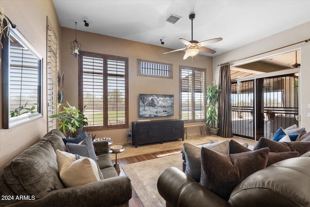 living room featuring ceiling fan and hardwood / wood-style flooring