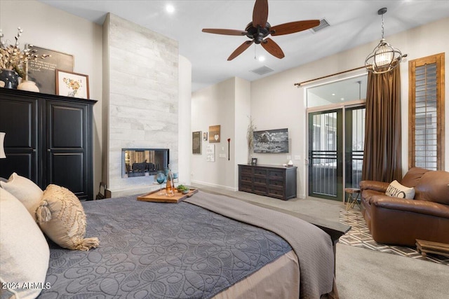 carpeted bedroom featuring a fireplace and access to outside