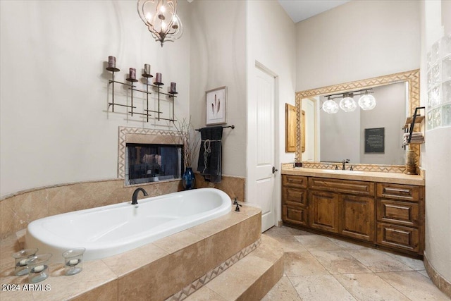 bathroom featuring a relaxing tiled tub and vanity