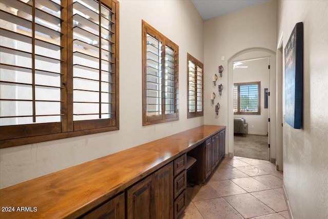 corridor featuring light tile patterned floors