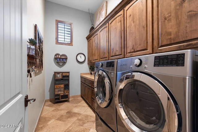 washroom featuring cabinets and separate washer and dryer