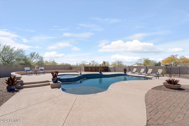 view of swimming pool with a patio area and an in ground hot tub