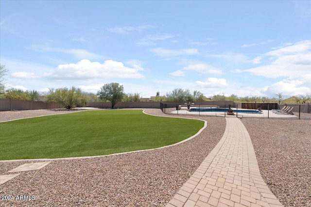 view of community featuring a lawn and a pool