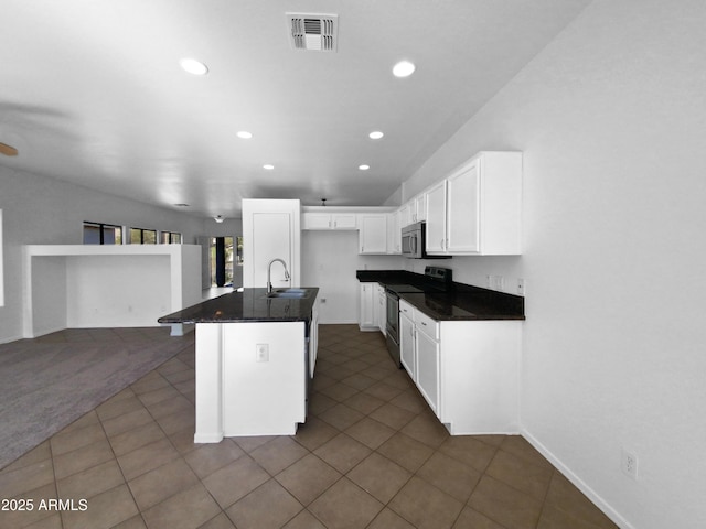 kitchen featuring stainless steel appliances, a kitchen island with sink, a breakfast bar area, white cabinets, and sink