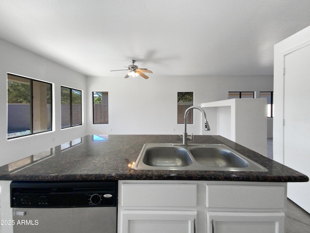 kitchen with stainless steel dishwasher, ceiling fan, white cabinetry, and sink