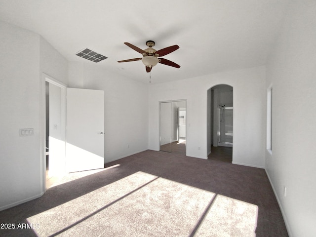 unfurnished bedroom featuring ceiling fan and dark colored carpet