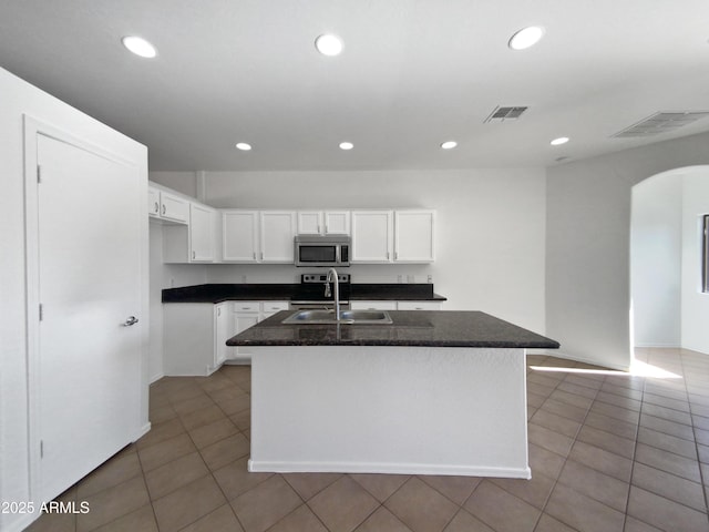 kitchen featuring sink, white cabinetry, a center island with sink, and light tile patterned floors