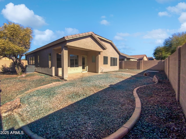 back of house with a patio and central AC unit