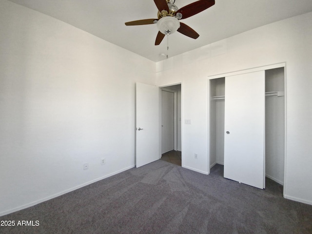 unfurnished bedroom with a closet, ceiling fan, and dark carpet