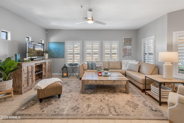 tiled living room with ceiling fan and plenty of natural light