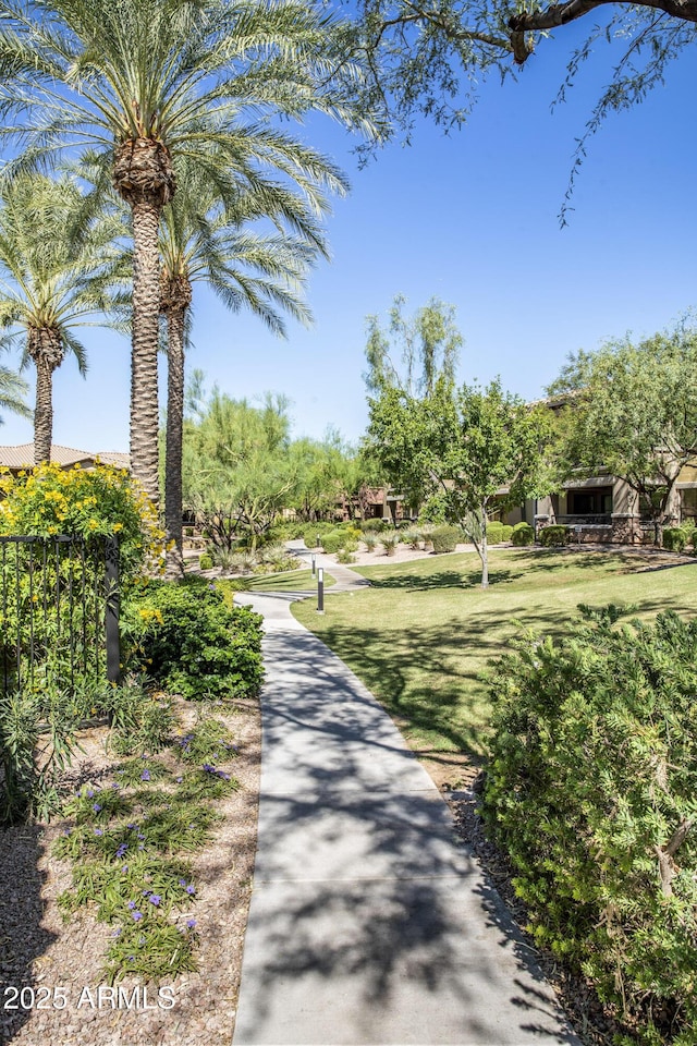 view of property's community featuring a yard