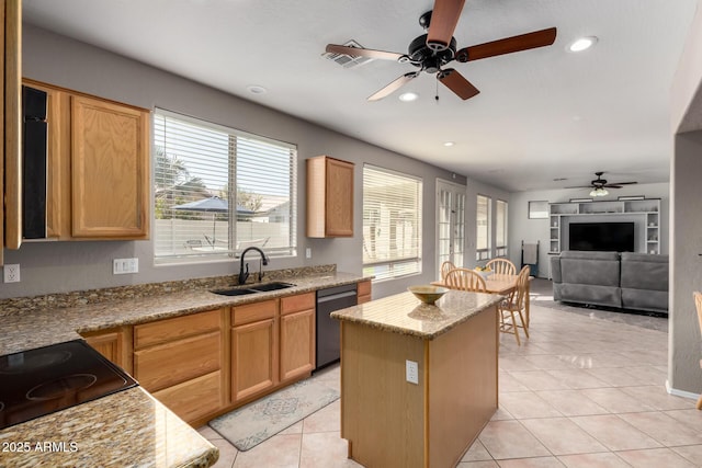 kitchen with sink, light tile patterned floors, dishwasher, light stone countertops, and a kitchen island