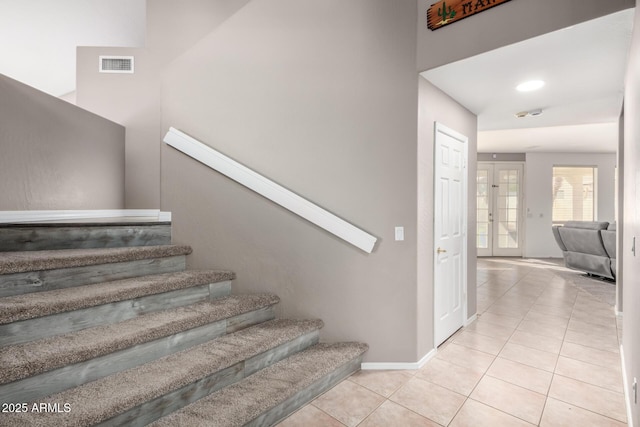 stairs featuring tile patterned flooring