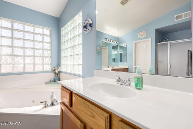 bathroom featuring vanity, lofted ceiling, and shower with separate bathtub