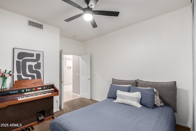 bedroom with ceiling fan and dark carpet