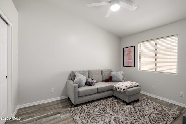 living room with hardwood / wood-style floors, vaulted ceiling, and ceiling fan