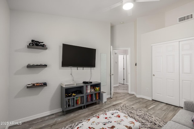 living room featuring wood-type flooring and ceiling fan