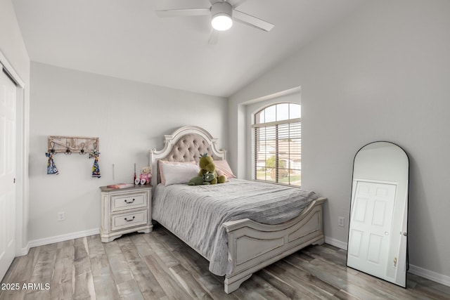 bedroom with hardwood / wood-style flooring, vaulted ceiling, and ceiling fan