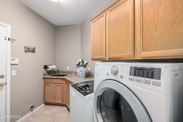 washroom with cabinets, light tile patterned flooring, sink, and independent washer and dryer