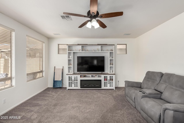 carpeted living room with ceiling fan