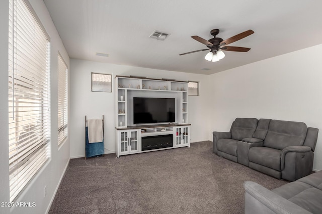 carpeted living room featuring ceiling fan