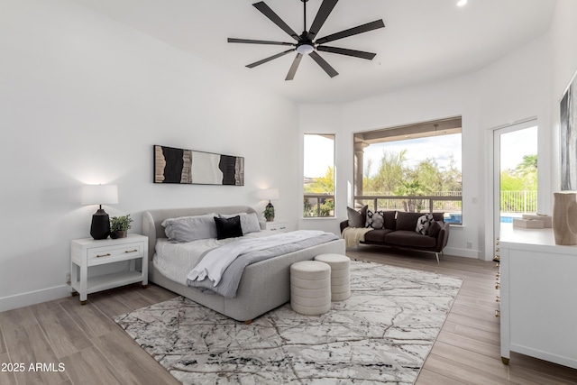 bedroom with access to outside, baseboards, wood finished floors, and a ceiling fan