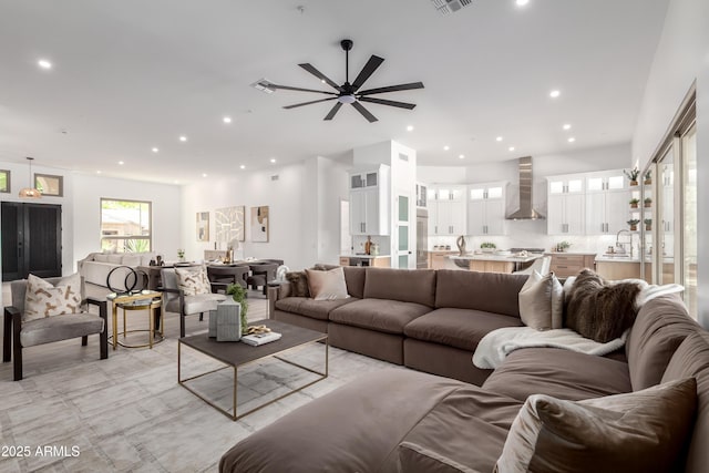 living area with recessed lighting and a ceiling fan