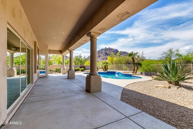view of patio with a mountain view and a fenced backyard