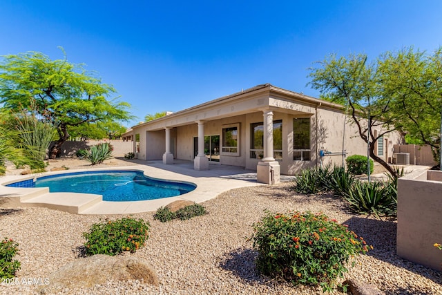 view of swimming pool featuring a patio area, a fenced backyard, and cooling unit