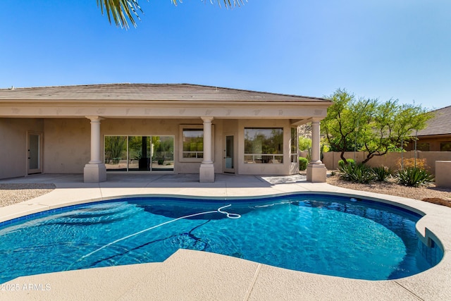 view of swimming pool with a patio area and fence