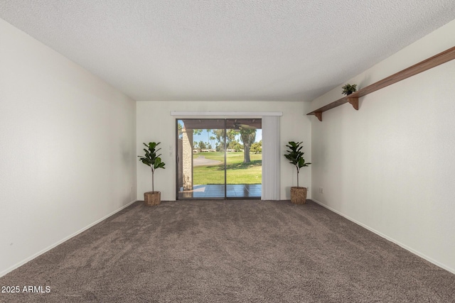 empty room featuring carpet floors, baseboards, and a textured ceiling
