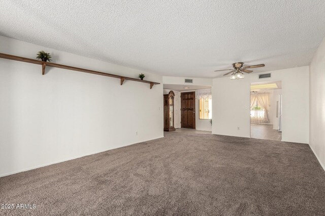 unfurnished living room featuring carpet floors, a ceiling fan, visible vents, and a textured ceiling