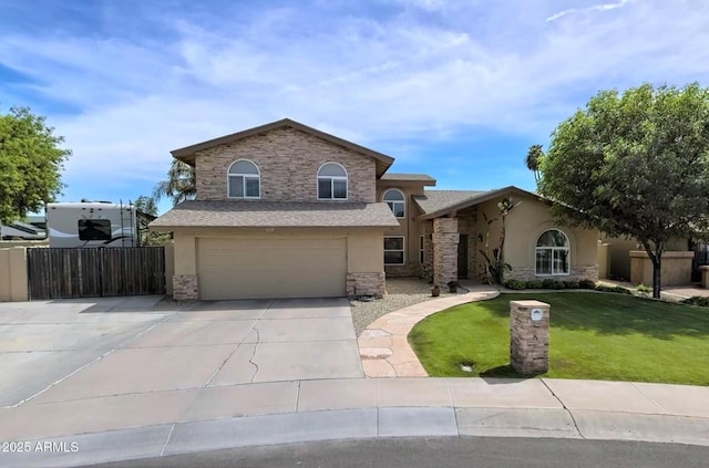 view of front facade with a front lawn, fence, stucco siding, driveway, and an attached garage