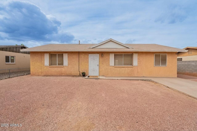 single story home with stucco siding and fence