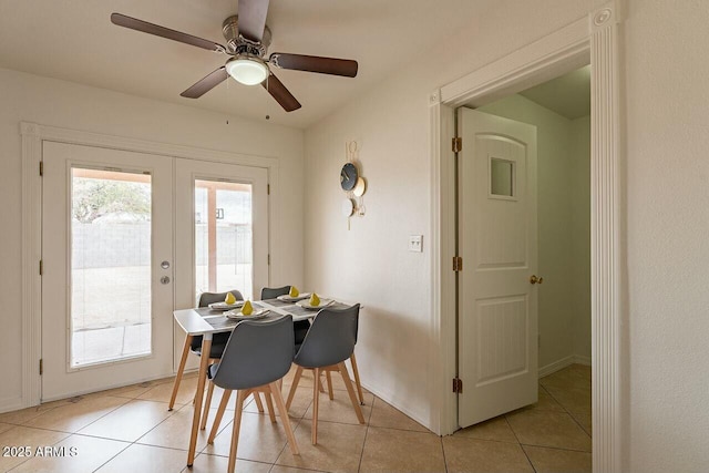 dining room with light tile patterned floors, french doors, baseboards, and ceiling fan