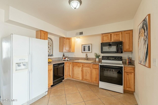 kitchen featuring visible vents, light tile patterned flooring, a sink, black appliances, and light countertops