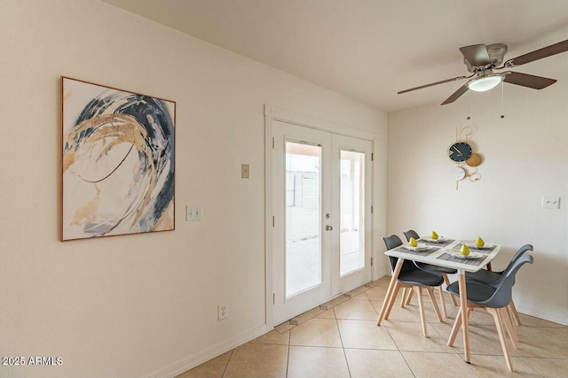 dining area with light tile patterned flooring, french doors, a ceiling fan, and a wealth of natural light