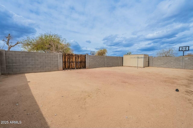 view of yard with a shed, an outdoor structure, and a fenced backyard