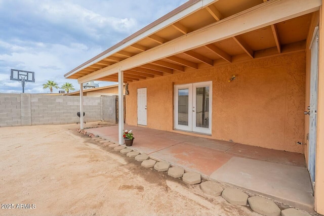 view of patio / terrace featuring french doors and fence